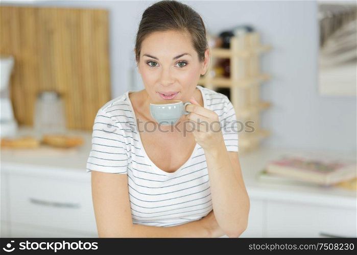 woman with cup of coffee indoors closeup