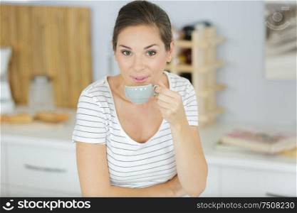 woman with cup of coffee indoors closeup
