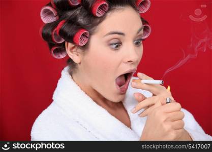 Woman with curlers and lit cigarette