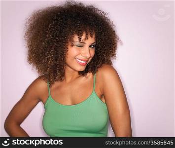 Woman with Curly Hair winking in studio half-length