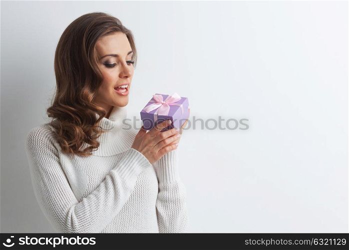 Woman with decorated gift box. Woman hold christmas or new year decorated gift box