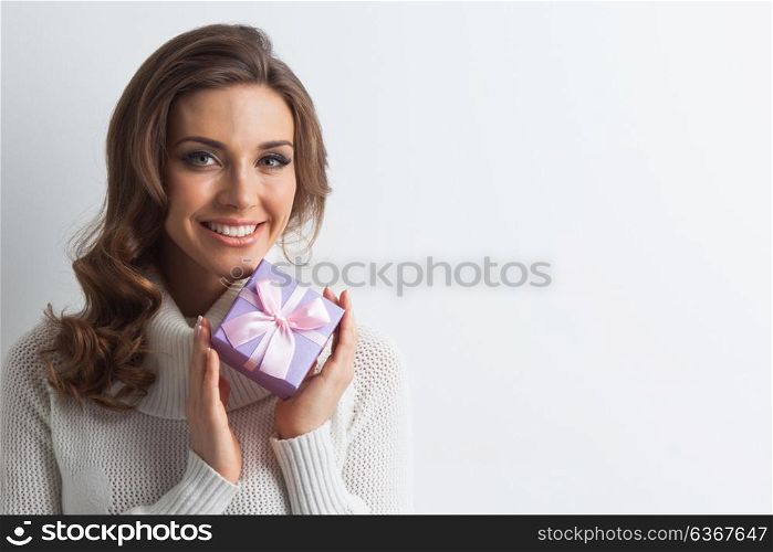 Woman with decorated gift box. Woman hold christmas or new year decorated gift box