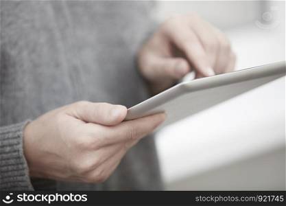 Woman with digital tablet surfing the web. Close-up view