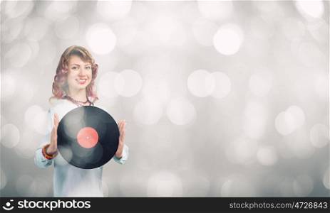 Woman with disco plate. Young woman in casual holding disco plate on bokeh background