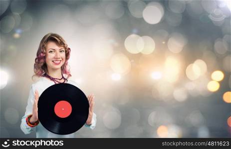 Woman with disco plate. Young woman in casual holding disco plate on bokeh background
