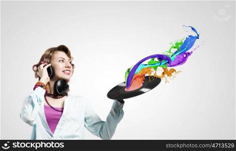 Woman with disco plate. Young woman in casual wearing headphones and holding disco plate