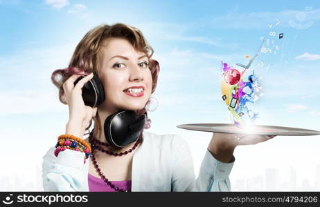 Woman with disco plate. Young woman in casual wearing headphones and holding disco plate