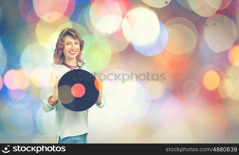 Woman with disco plate. Young woman in casual wearing headphones and holding disco plate