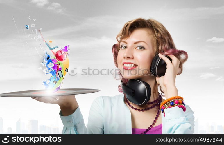 Woman with disco plate. Young woman in casual wearing headphones and holding disco plate