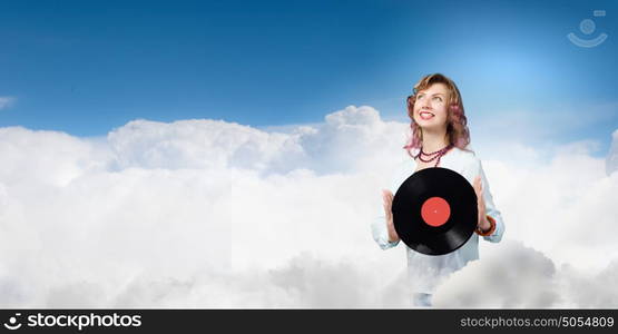 Woman with disco plate. Young woman in casual wearing headphones and holding disco plate