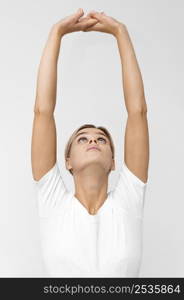 woman with doing physiotherapy while lifting arms up