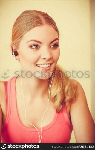 Woman with earphones listening to music. Leisure.. Young woman with earphones listening to music. Girl relaxing enjoying. People relax leisure pleasure concept.