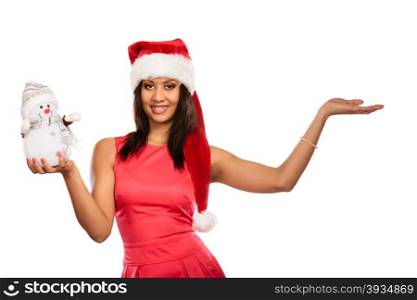 Woman with empty hand in santa hat holds snowman.. Happy cute woman with empty blank palm hand in santa claus hat holding little snowman. Attractive mixed race african girl isolated. Christmas copy space advertisement.