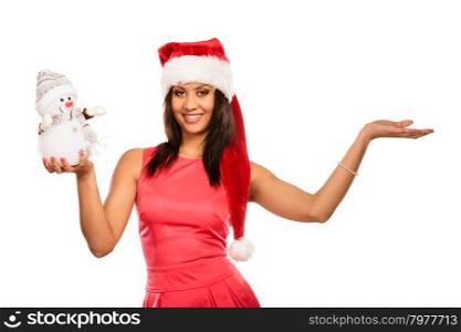 Woman with empty hand in santa hat holds snowman.. Happy cute woman with empty blank palm hand in santa claus hat holding little snowman. Attractive mixed race african girl isolated. Christmas copy space advertisement.