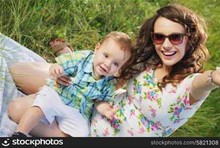 Woman with fabulous smile and her cute little son