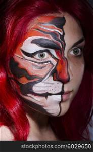 Woman with face painting in dark room
