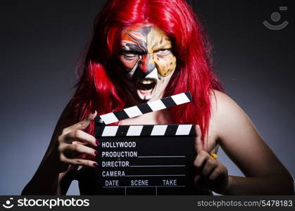 Woman with facepaint and movie clapper
