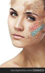 woman with fantasy coloured powder on face on white background