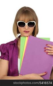 Woman with files and oversized sunglasses