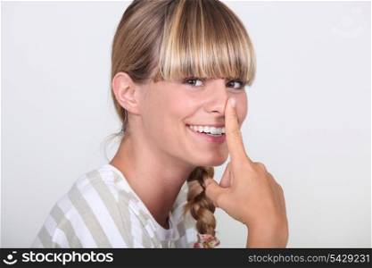 Woman with finger on her nose