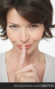 Woman with Finger on Lips