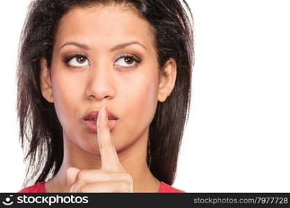 Woman with finger on lips showing silence gesture.. Young mixed race woman girl with finger on lips showing hand quiet silence sign gesture isolated on white.