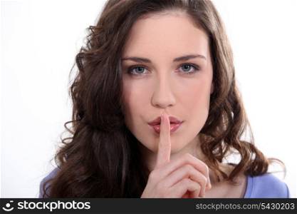 Woman with finger over mouth