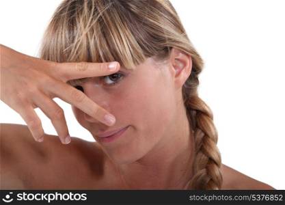Woman with fingers forming a V
