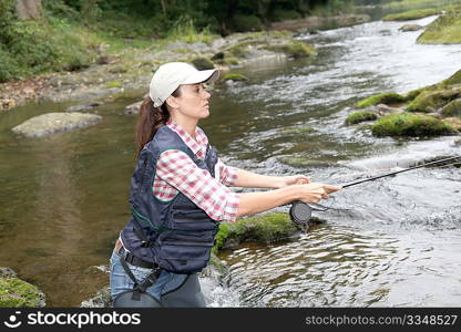 woman with fly fishing rod in river