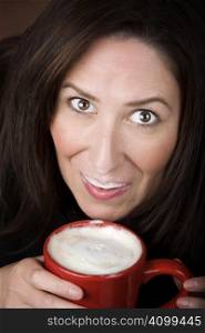Woman with foam from coffee specialty drink on her lip and nose
