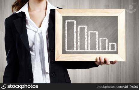 Woman with frame. Young woman holding frame with decreasing graph