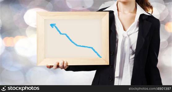 Woman with frame. Young woman holding frame with increasing graph