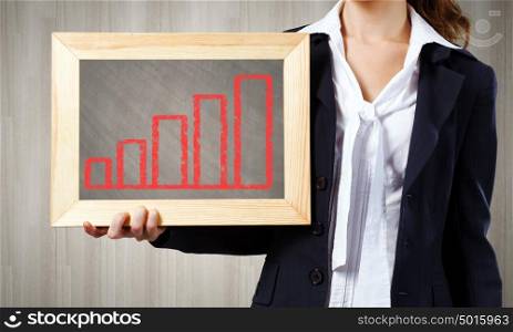 Woman with frame. Young woman holding frame with increasing graph