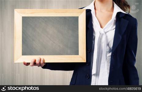 Woman with frame. Young woman holding wooden frame with cloud scape