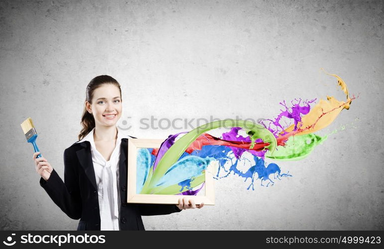 Woman with frame. Young woman holding wooden frame with colorful splashes