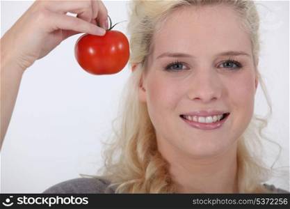 Woman with fresh tomato