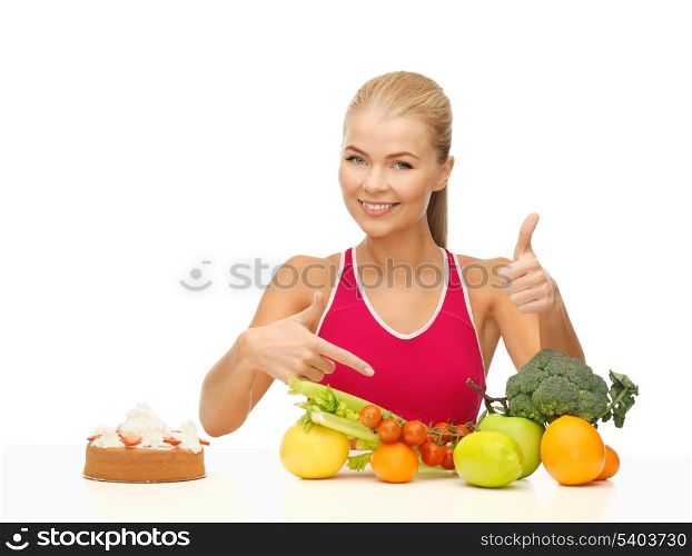 woman with fruits and cake pointing at healthy food