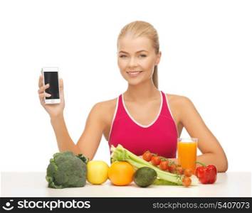 woman with fruits and vegetables counting calories in smartphone