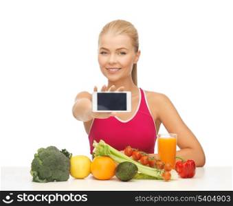 woman with fruits and vegetables counting calories on smartphone