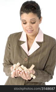 Woman with frustrated expression and hand full of wooden puzzle pieces.