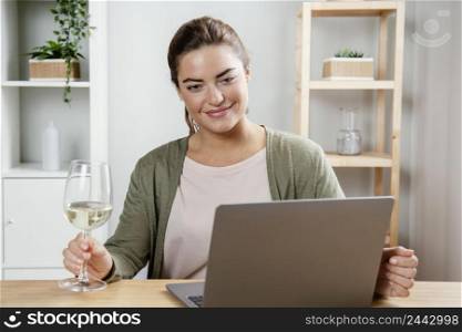 woman with glass wine using laptop