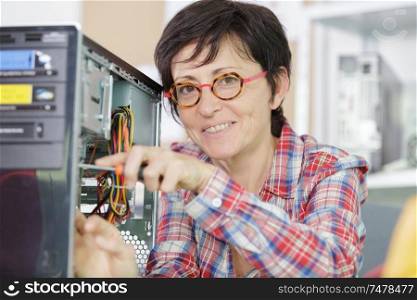 woman with glasses fixing a broken processor