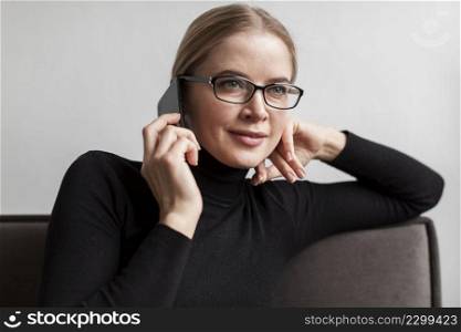 woman with glasses talking phone