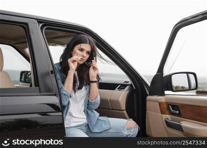 woman with glasses traveling alone by car