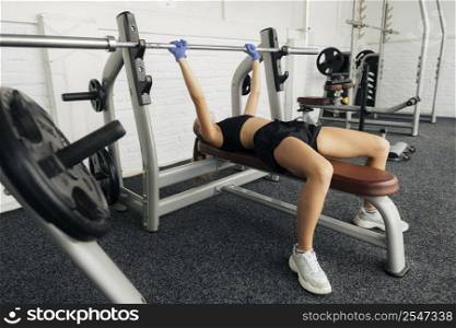 woman with gloves working out gym