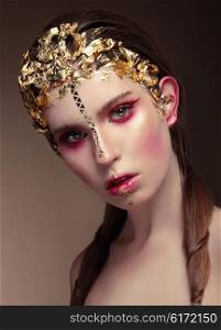 Woman with gold face make up fashion on brown background.