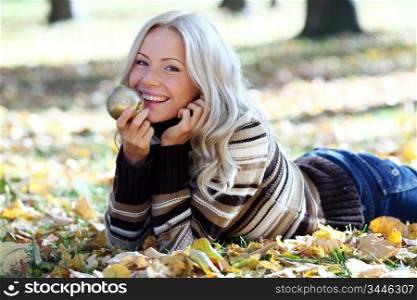 woman with golden apple in autumn park