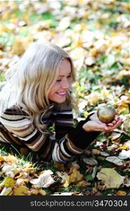 woman with golden apple in autumn park