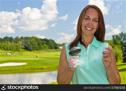 Woman with golf ball and club on the fairway