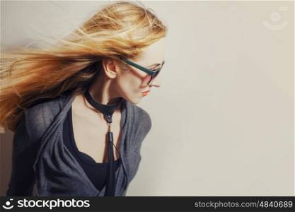 Woman with hair blowing in wind on white studio background